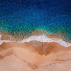 Ocean waves wash onto a sandy beach.